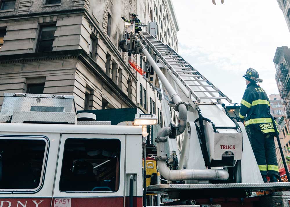 Fire Truck Ladder reaching to fire in building